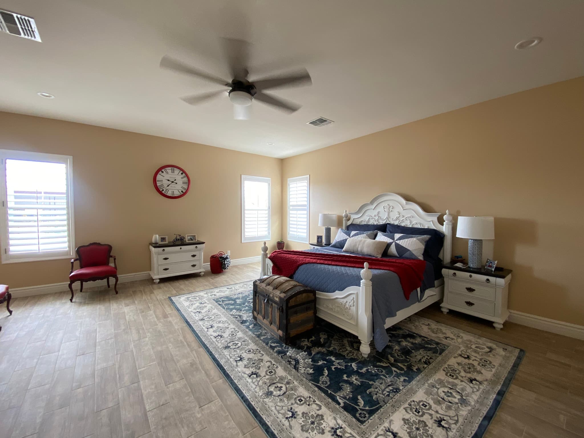 Completed primary bedroom with finished flooring, paint, trim, and windows